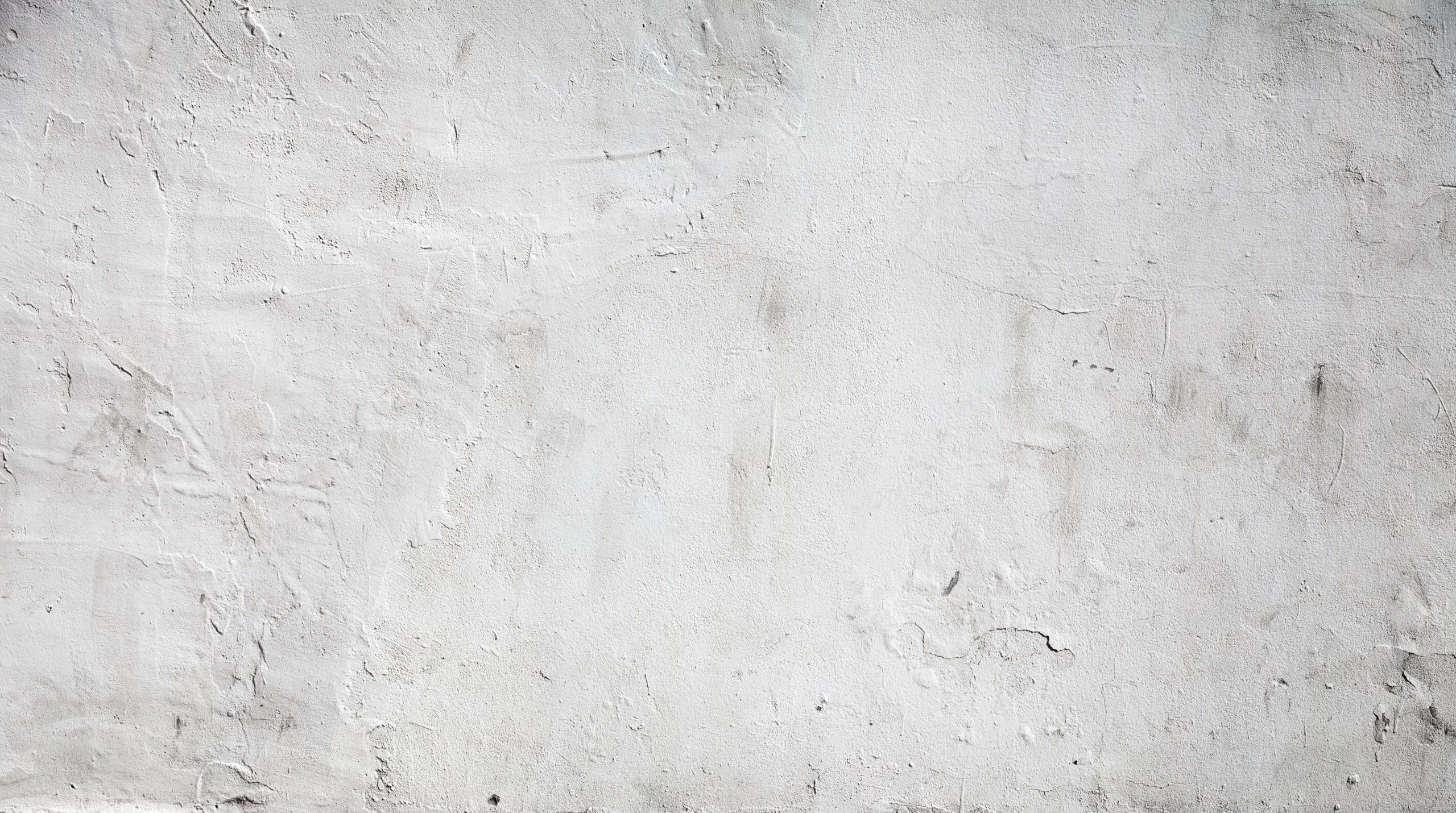 Rough white plastered wall texture with visible cracks and imperfections.
